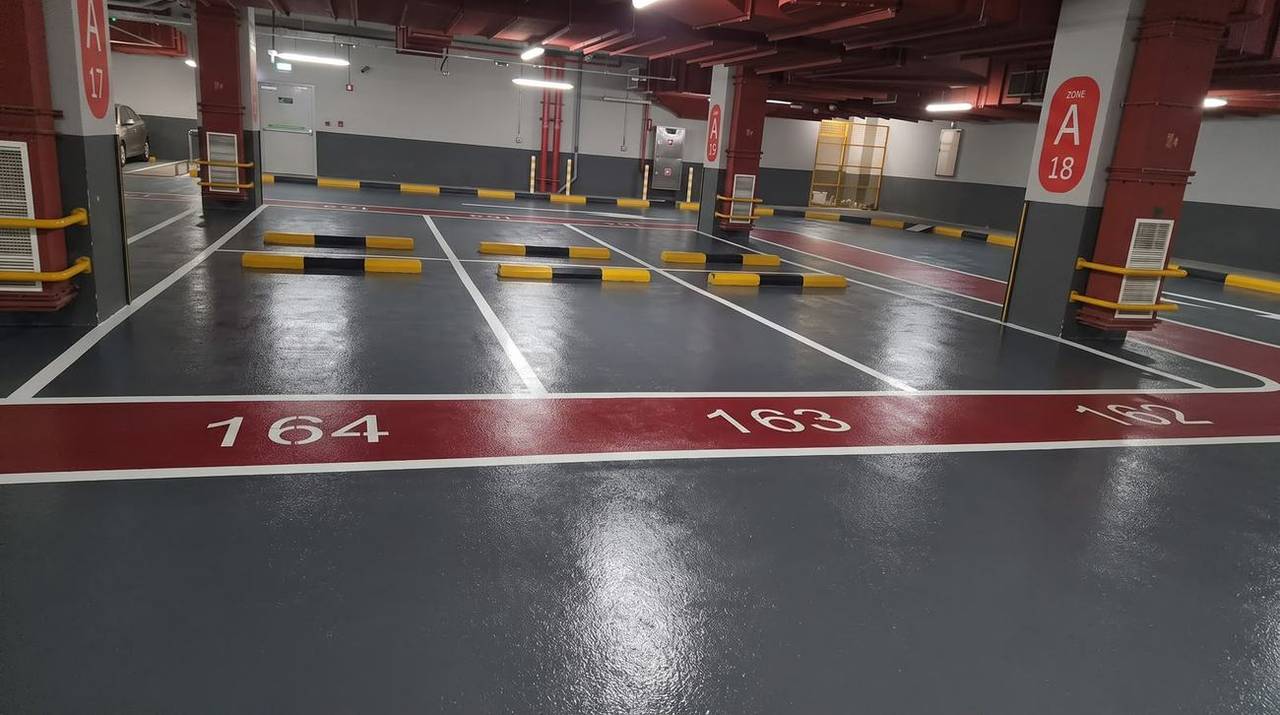Car park epoxy flooring with aggregate — colour-coded bays and numbering — Oasis Mall, Sharjah