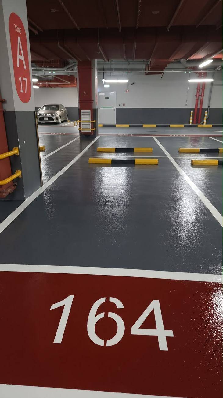 Car park epoxy flooring — numbered bay in zone colour — Oasis Mall, Sharjah