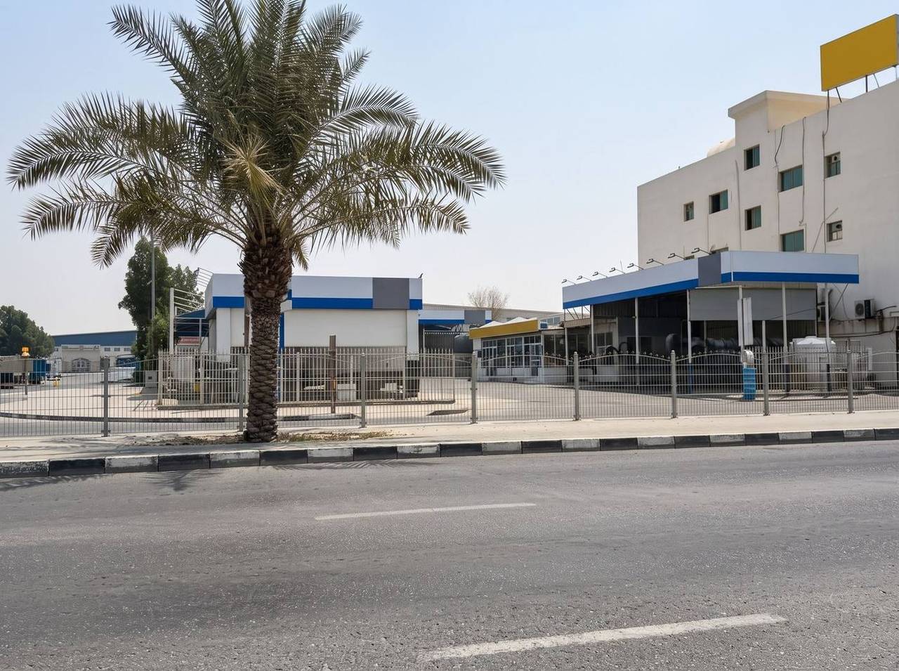 Commercial building (G+3) with car-wash units — Industrial Area 3, Al Senaiyat
